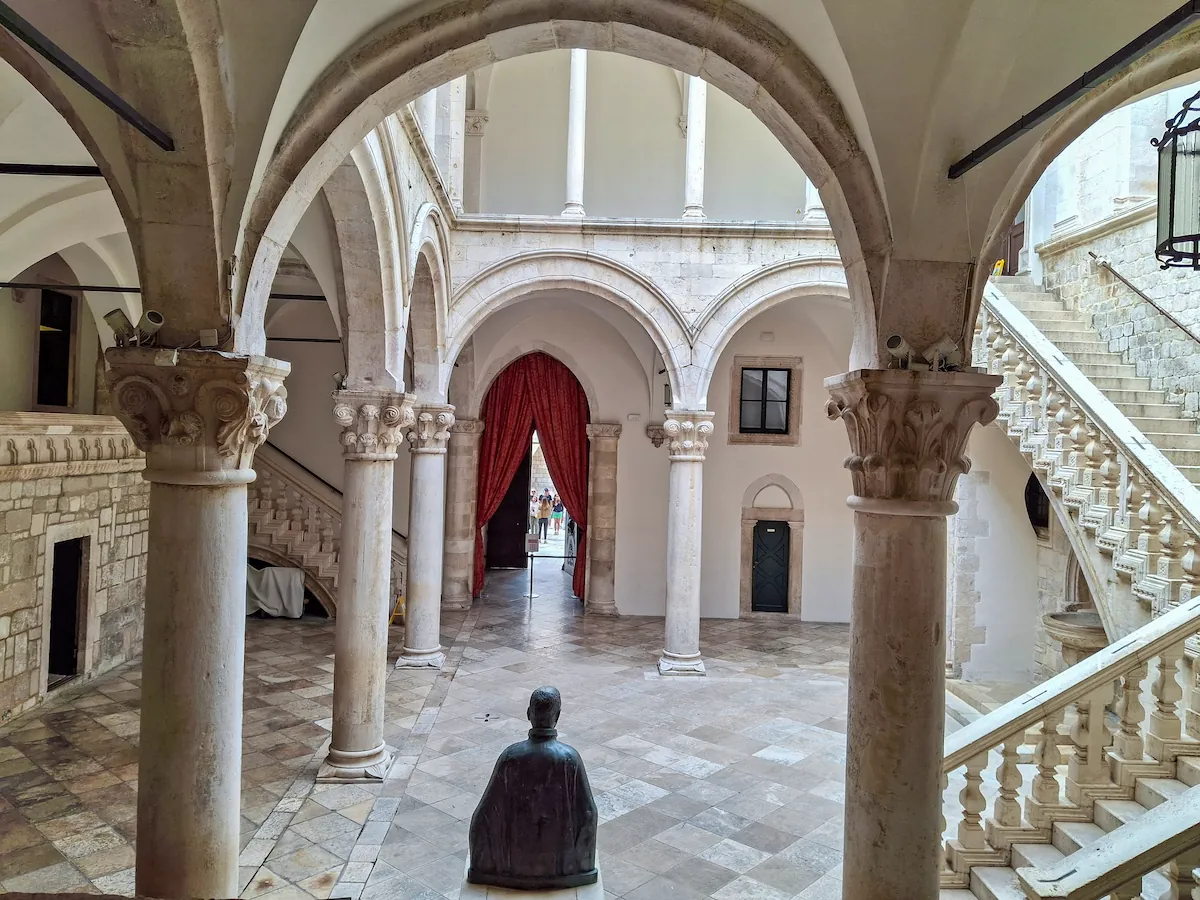 The elegant Gothic and Renaissance arches and stone pillars inside the Rector Palace courtyard