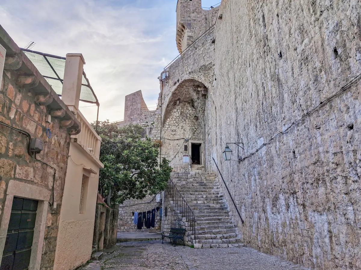 Street-level entrance path at the base of Minčeta Tower leading toward the City Walls tunnel access
