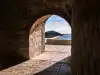 View through a stone archway of Fort Lovrijenac toward Lokrum Island