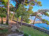 View from the far end of Gradac Park showing trees and a side view of Danče Beach below