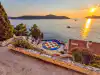 Wide view of the Hotel Belvedere amphitheater with Lokrum Island under late afternoon sunlight