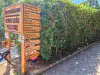 Wooden welcome sign and directional waypoint arrows on Lokrum Island