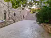 Stone courtyard on Margarita Street with the side facade of St. Margarita Church near the Dubrovnik City Walls