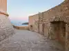 View along the curved stone path around the base of Minčeta Tower looking toward the old town and the sea