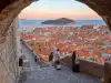 Open view of the old town rooftops and city wall pathway from the interior of Minčeta Tower