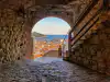 Dubrovnik old town rooftops framed through an interior stone archway of Minčeta Tower