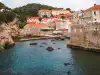 Panoramic view looking down on the Pile Bay stone pier and its rocky shore from Bokar Fortress