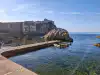 Side view of the stone pier in Pile Bay with Bokar Fortress standing in the background
