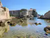 View from the Pile Bay stone pier looking across the rocky shore toward Bokar Fortress