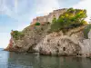 Bottom-up view from the Pile Bay stone pier looking up toward St. Lawrence Fortress and its cliffside stairs