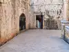 Close-up view looking down the entrance ramp toward the small passage in Dubrovnik Old Town