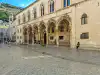 Exterior view of the Rector's Palace showing the stone arches and upper windows