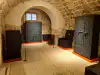Interior exhibition room displaying antique chests and trunks inside the Rector's Palace