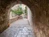 View from within the stone archway passage directly in front of the Rupe Museum entrance looking back along the approach path