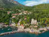 Aerial view of the Trsteno Arboretum coastline, harbor, and lush hillside