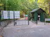 Trsteno Arboretum entrance and wooden ticket booth behind fence