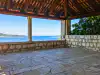 Interior view of Trsteno Arboretum gloriet looking past stone columns toward Lopud island, showing a glimpse of Šipan island