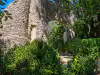 Side profile behind the Poseidon fountain showing the historic stone aqueduct structure at Trsteno Arboretum