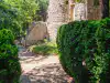 Back view of the Poseidon fountain at Trsteno Arboretum, showing the massive rough-stone aqueduct wall behind it
