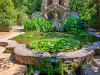 Front view of Poseidon fountain statues and water lily covered basin in Trsteno Arboretum