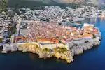 A panoramic aerial view of Dubrovnik’s Old Town surrounded by medieval walls and fortresses